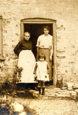 old photo of a family in a farm doorway